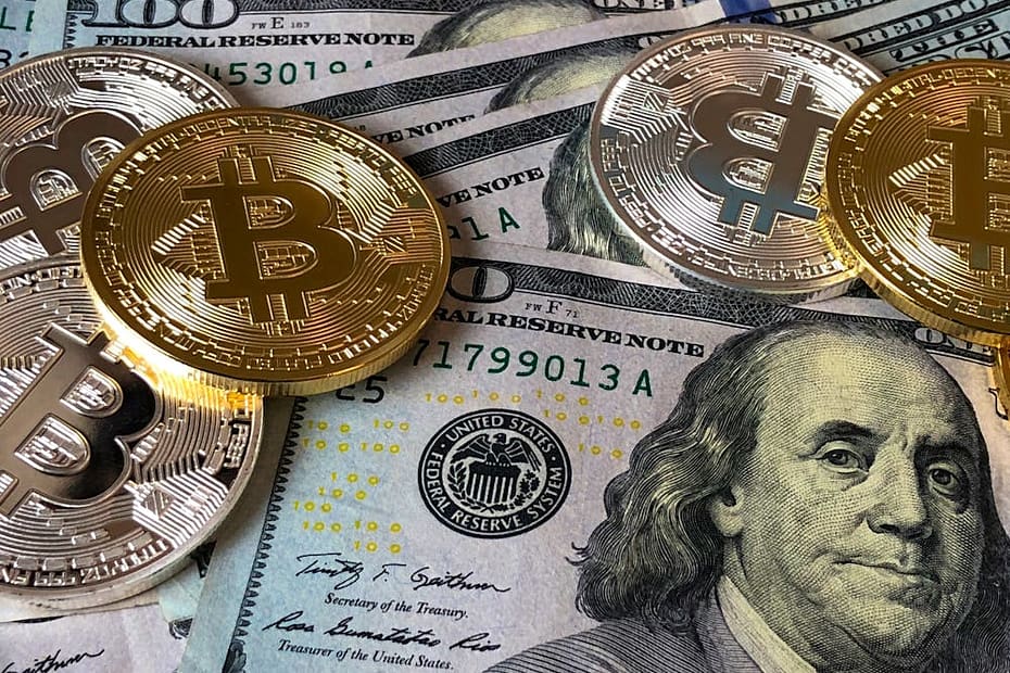 Bitcoin coins and dollar bills representing cryptocurrency in online gambling